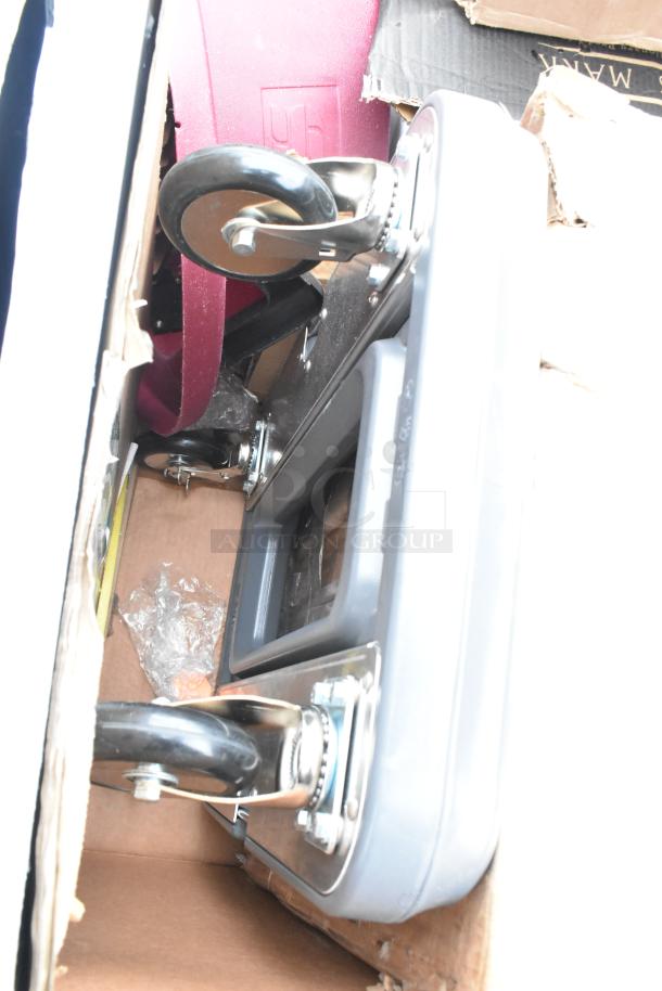 Boxed items including a cart with visible wheels and a red item, labeled "96." New, scratch and dent condition.