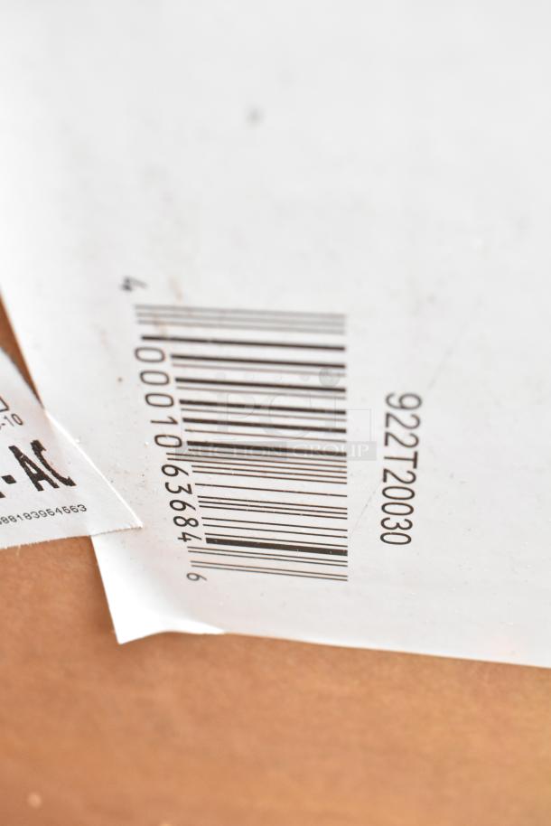 Barcode on a box, likely part of an auction lot containing brand new scratch and dent items, including gloves, cart, and ingredient bin.