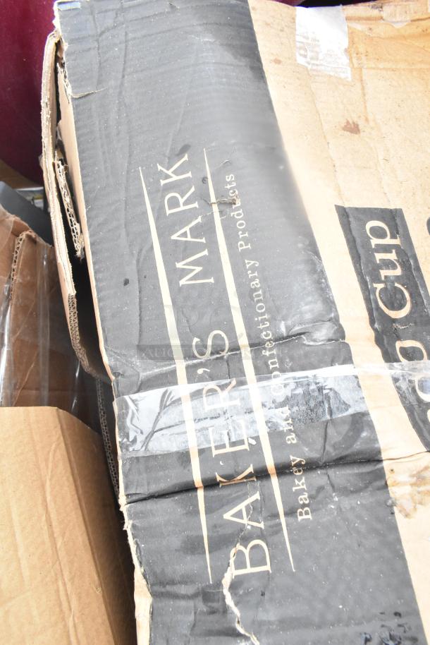 Cardboard box labeled "Baker's Mark" with visible wear and tear, likely containing new scratch and dent items.