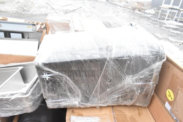 15 new scratch and dent items, including splash guard, flight paddle, and ingredient bin, wrapped on pallets.