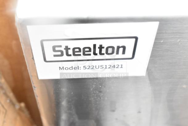 Steelton item label showing model 522US12421. The item is part of a scratch and dent lot, including splash guard and more.