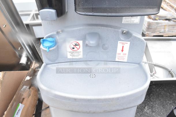 Brand new scratch and dent portable hand wash sink with foot pump, manual fill, and "not for drinking" warning label.