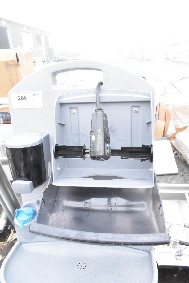 "Brand new portable hand wash sink, scratch and dent condition, with soap dispenser and electrical attachment visible."