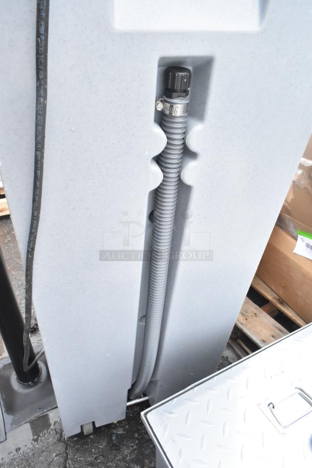 Brand new scratch and dent portable hand wash sink with hose attachment, light gray body, and sturdy base.