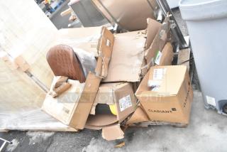 Boxes containing brand new items, some damaged packaging, including a floor mat and wall shelf labeled "Clariant."
