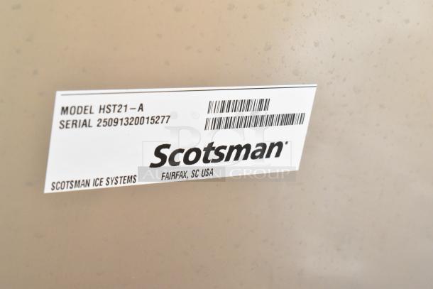 2025 Scotsman HST21-A ice dispenser stand, stainless steel, new with scratches, label shows model and serial number.