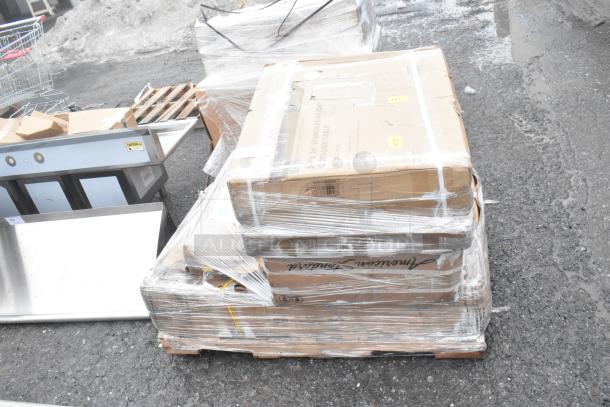 Pallet with 5 new scratch and dent items including work table, shelf; wrapped in plastic, visible carton labels.
