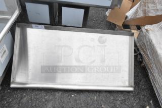 Brand new scratch and dent wall shelf, stainless steel, slight imperfections visible, item tag reads "Qty 1 - 276".