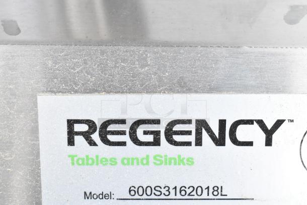 Regency stainless steel 3 bay sink label, model 600S3162018L, new condition, with visible scratch and dent.