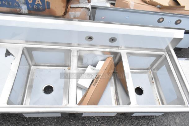 BRAND NEW Regency 600S3162018L stainless steel 3 bay sink with left side drain board, showing scratch and dent condition.