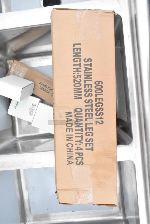 Brand new Regency 600S3162018L 3 bay stainless steel sink with left side drain board, visible scratch and dent, boxed leg set.