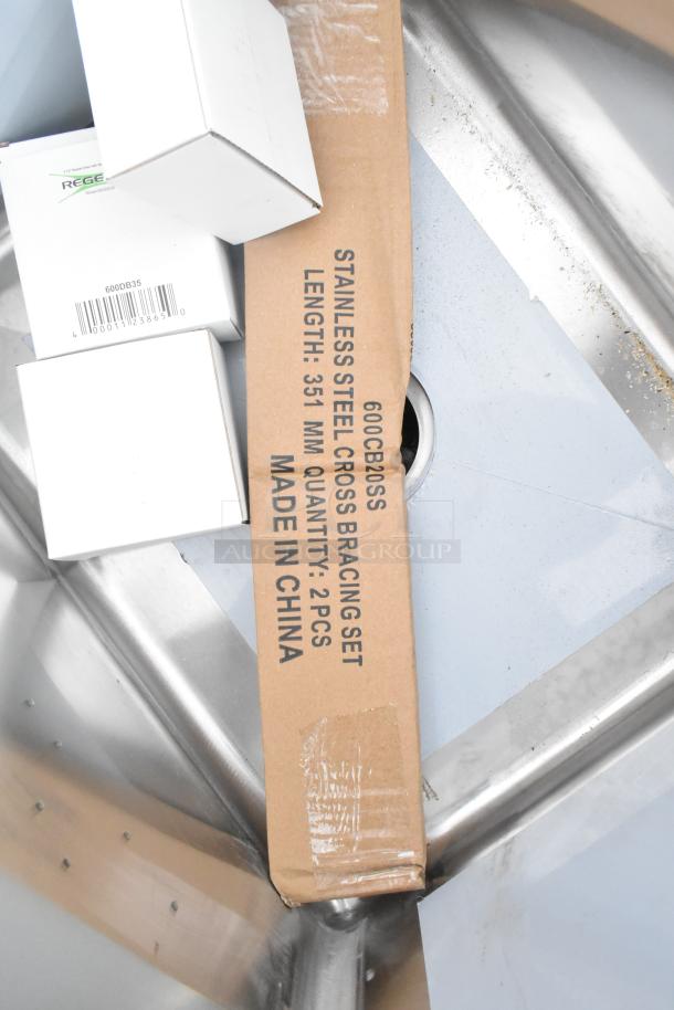 Regency 600S3162018L stainless steel 3-bay sink with left side drainboard, brand new with minor scratches. Includes cross bracing set.