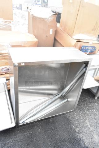 Brand new metal bin with minor scratches, industrial design. Perfect for storage. Visible boxes and labels in the background.