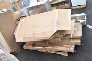 15 new scratch and dent items including a sink, shelving posts, and outdoor table in original packaging.