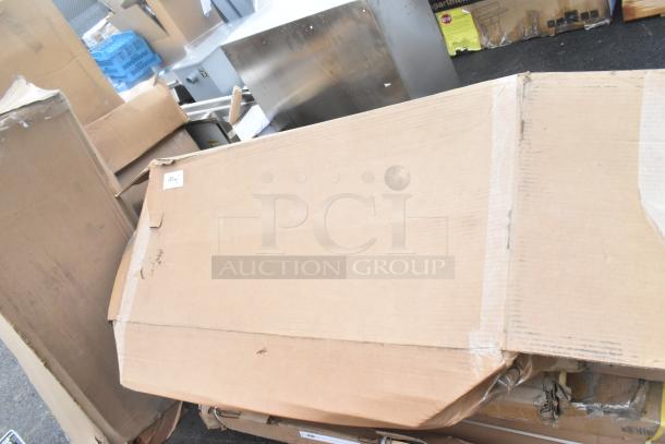 15 brand new items including a sink, shelving posts, and outdoor table in various boxes, some with scratches and dents.