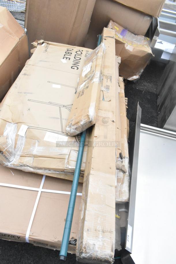 15 brand new scratch and dent items, including a boxed sink, shelving posts, and an outdoor table. Boxes show wear.