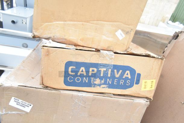 Cardboard boxes labeled "Captiva Containers" showing minor wear. Includes scratch and dent items, likely sinks. FedEx Ground returns label visible.