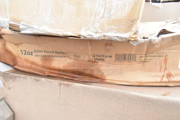 Box of 12oz bullet round bottles, 38mm DS1.5 neck finish, with visible scratches and stains on packaging, 210 units per case.