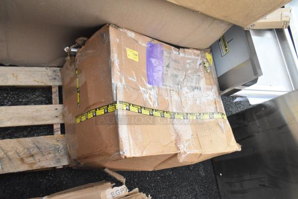 Cardboard box labeled "Caution" containing 5 scratch and dent items, including sinks, on a wooden pallet.