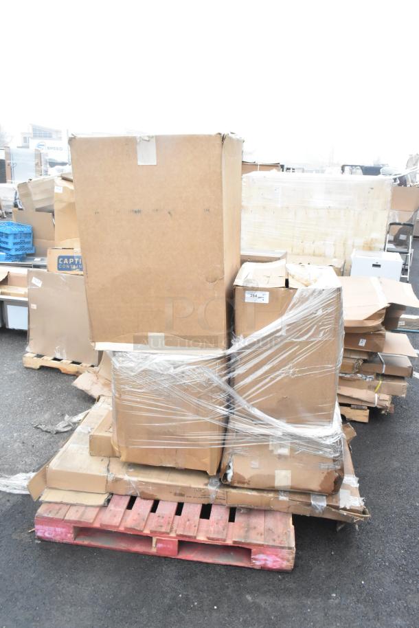Shrink-wrapped pallet with cardboard boxes, marked "284." contains scratch and dent pie pans and work table. Auction lot.