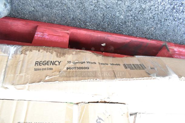 Regency 18 gauge work table box marked 30x60, partially dented. Includes pie pans, new scratch and dent items.