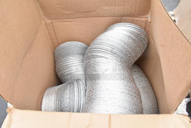 Box of multiple new aluminum pie pans, part of a scratch and dent auction lot.