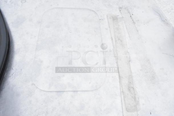 Transparent protective covers on a soft drink machine surface; no visible doors or hardware.