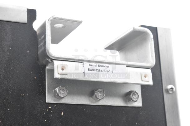 Black swinging kitchen door corner with metal hardware and serial number EQ00325270-1-1-1 visible.