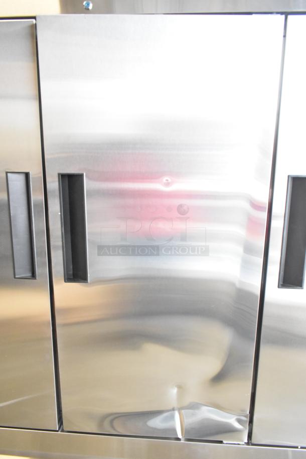 Brand new KoolMore RIF-3D-SS commercial 3-door freezer, 72 cu ft, with visible dents; 115 volts, 1 phase.