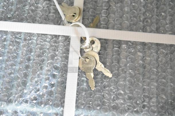 Keys on bubble wrap for KoolMore RIF-3D-SS commercial freezer. New, scratch and dent, 72 cu ft, 115V, 1 phase.