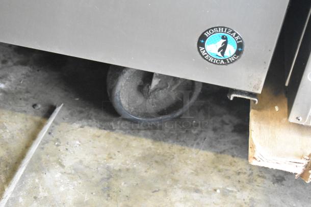 Hoshizaki CRMR60-24M commercial prep table caster, showing Hoshizaki America Inc. logo, on a concrete floor.