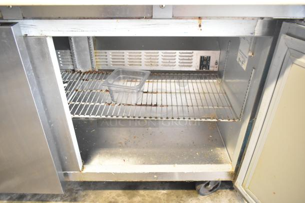 Hoshizaki CRMR60-24M sandwich salad prep table with bain marie top, commercial casters, visible wear, 115V, 1 phase.