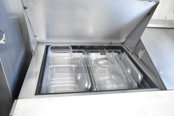 Hoshizaki CRMR60-24M prep table bain marie, commercial casters, showing open top with clear food pans inside.