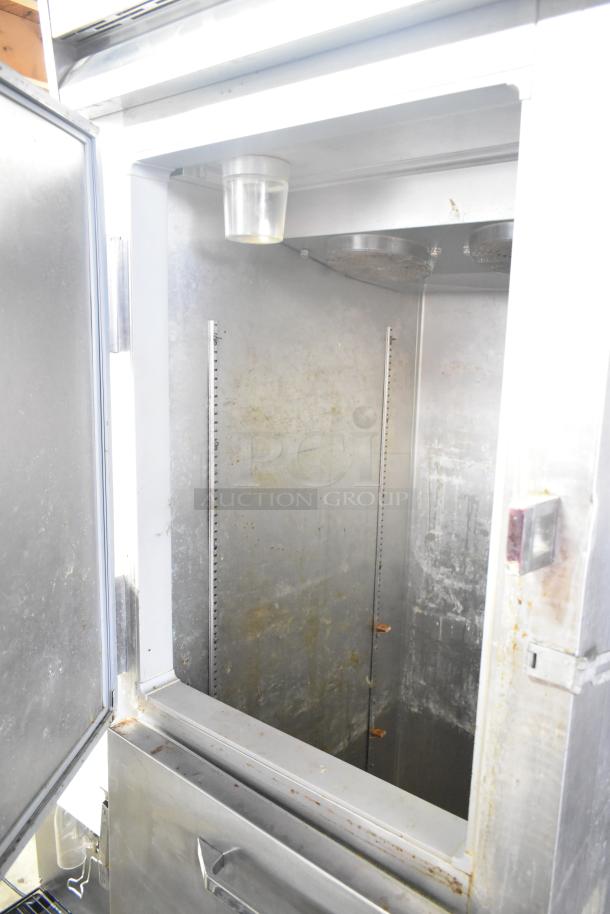 Continental 1R-HD commercial reach-in cooler, half-size, on casters. Visible wear, interior shelving tracks. 115V, 1-phase.