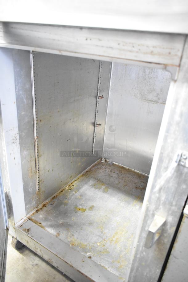 Continental 1R-HD commercial cooler interior, half size, stainless steel, on casters, visible wear and stains.