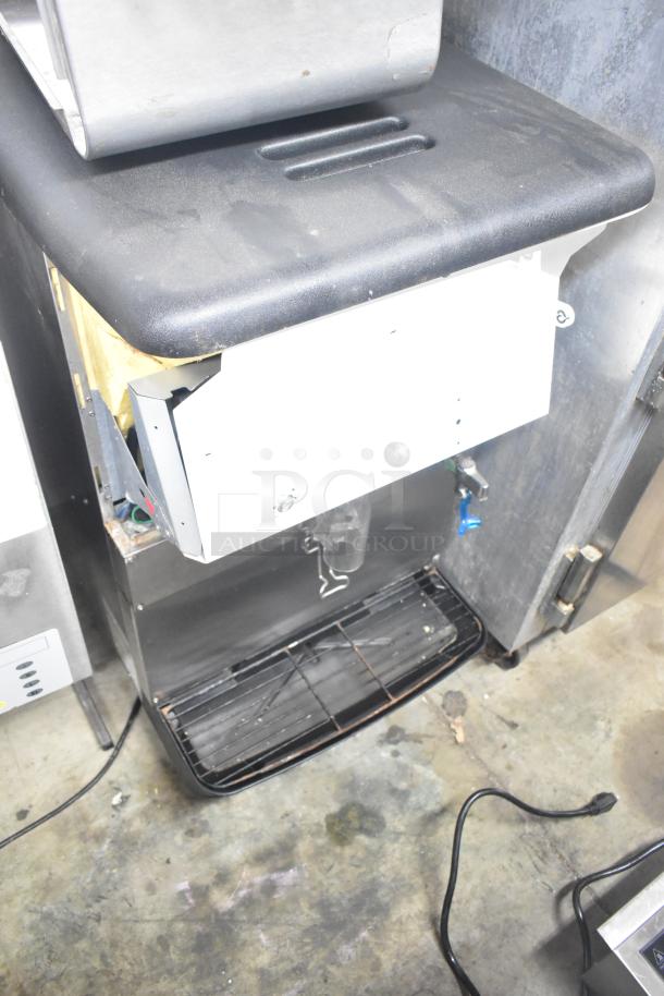 Cornelius ED150 commercial countertop ice dispenser, 115 volts, 1 phase, black and stainless steel finish. Visible wear on surface.