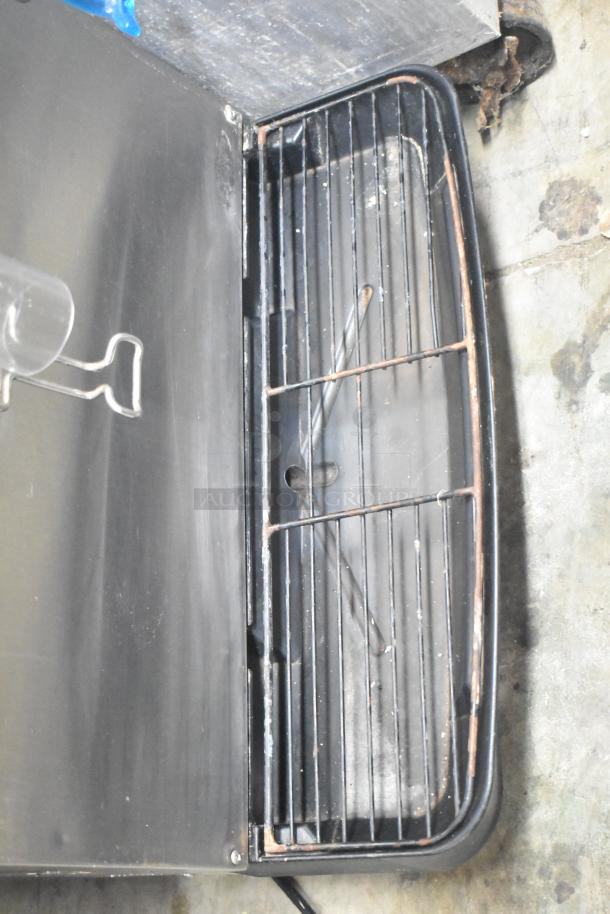 Cornelius ED150 commercial countertop ice dispenser with grid layout. 115 volts, 1 phase. Shows wear, suitable for parts.