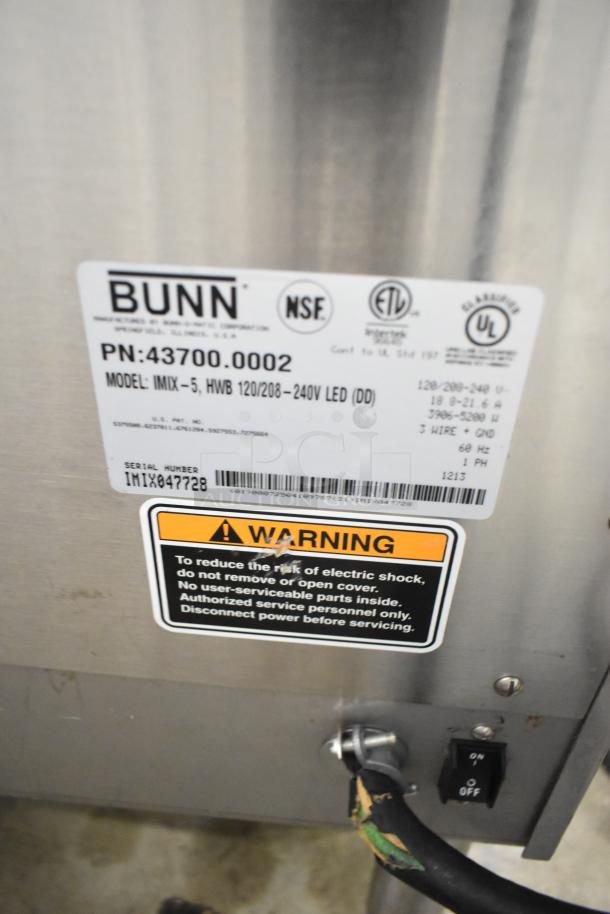 Bunn IMIX-5 stainless steel cappuccino machine, 120/208-240V, with equipment stand. Label showing model, voltage, and warnings.