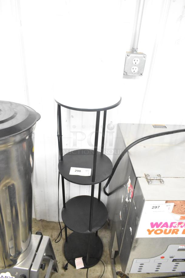 Light fixture with three round under shelves, black metal frame, in good condition. Tag reads "298 QTY 1".