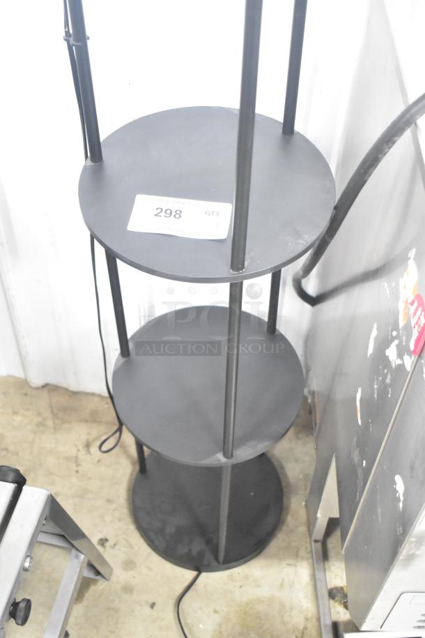 Black light fixture with three round under shelves, metal construction, and attached electric cord. Auction tag reads "298 QTY."