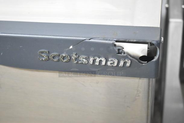Scotsman C0830SA-32B ice machine head, visible brand label, slight damage on panel, operates at 208/230 volts, 1 phase.