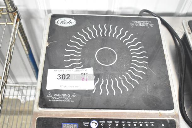 Globe IR1800 induction range, electric, single burner, metal countertop, 120 volts, visible wear, display reads warnings.