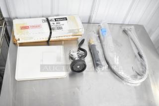 Eight assorted kitchen items including Lincoln Redco 0653 Tomato Blade Assembly, spray nozzle, and hoses, new condition.