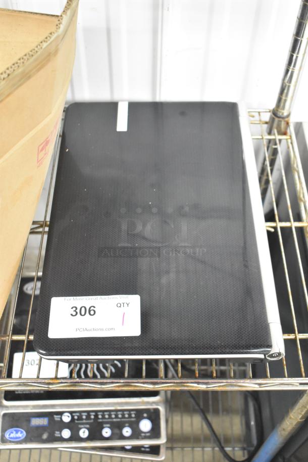 Gateway KAYF0 Laptop on shelf; black casing with visible white auction label "306 QTY 1".
