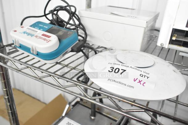 2 auction items: EnteraLite Infinity Pump and UniFi UAP-AC-PRO WiFi Access Point, each with visible labels on a metal shelf.