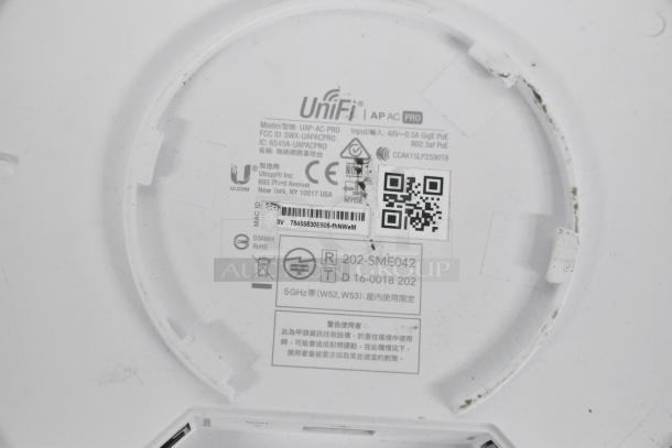 Label on UniFi UAP-AC-PRO WiFi Access Point showing model, FCC ID, power input, and compliance marks.