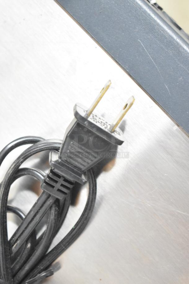 Altronix BH12DC8CB power supply box with visible power cord plug, showing good condition and minimal wear.