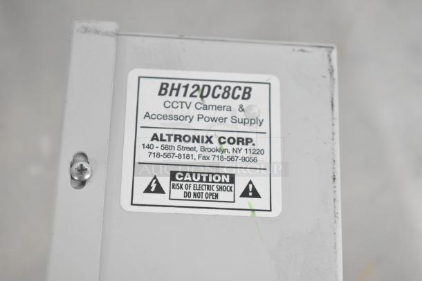 Altronix BH12DC8CB power supply box for CCTV, label shows model and caution for electric shock, clean condition.