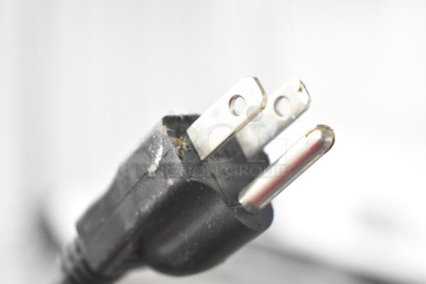 Close-up of a Global 246608 air curtain plug, showing a standard three-prong connector. 120 Volts, 1 Phase.