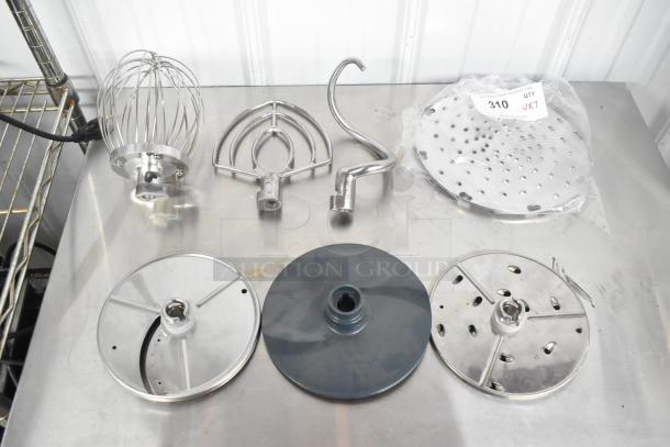Set of 7 attachments: whisk, paddle, dough hook, 2 processor blades, pelican head grater. Excellent condition. Lot label visible.